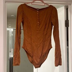 Free people bodysuit with thumb holes and gold tone detailing on the buttons